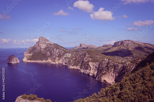 Mountain panorama view with blue sky, cumulus clouds and blue sea, ocean in Mallorca, Spain