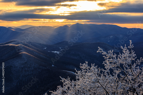 Devil's Knob Overlook – Sunset on Blue Ridge Mountains with ice covered trees in foreground and cloudy sky