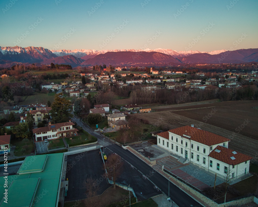 Fototapeta premium View from above between hills and snow-capped mountains