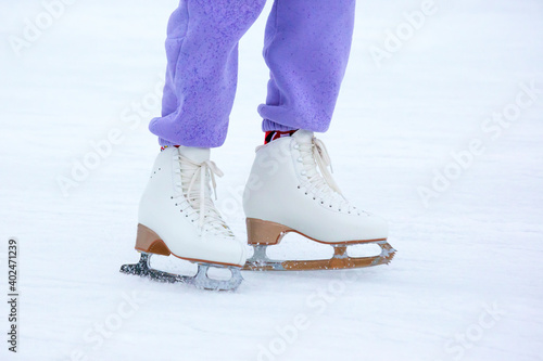 legs of a woman ice skating on an ice rink. hobbies and leisure. winter sports