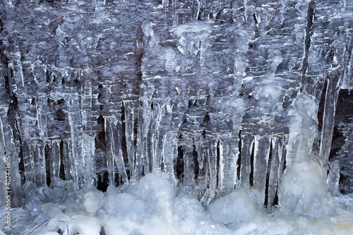 Icicles on a rocky wall photo