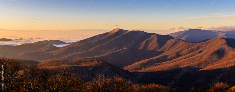 Devil's Knob Overlook– Panorama of Blue Ridge Mountains and low lying clouds shortly after sunrise in winter