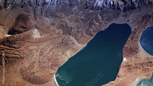 Lake and rock mountains aerial satellite view, Tibet China natural landscape sunrise animation. Images furnished by Nasa photo