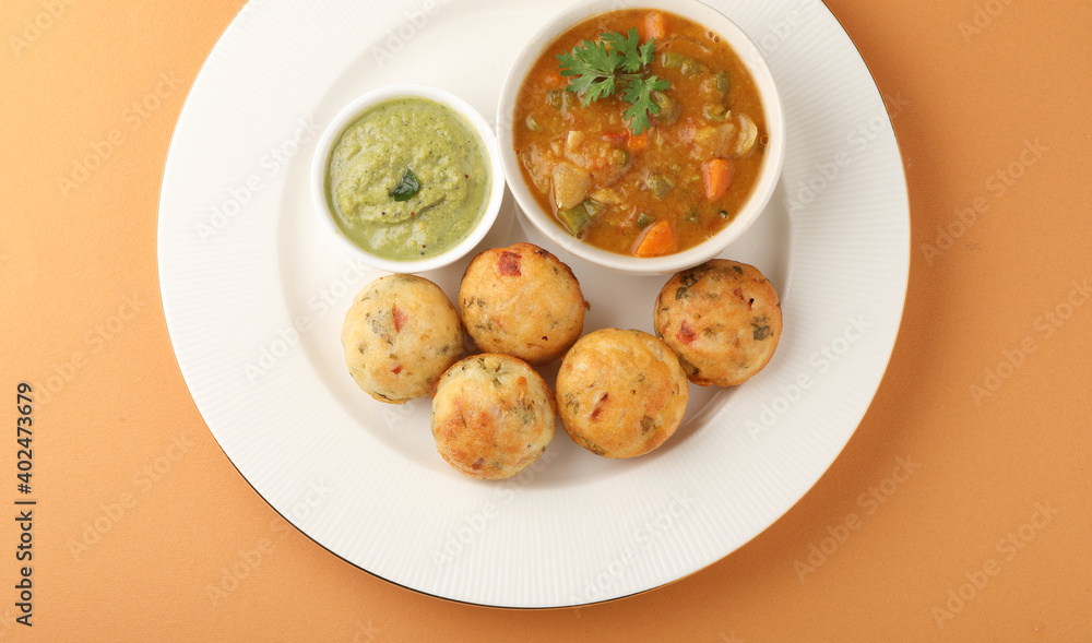 Kuzhi Paniyaram served with coconut chutney and sambar- South Indian breakfast Kuzhi Paniyaram served with coconut chutney and sambar- South Indian breakfast