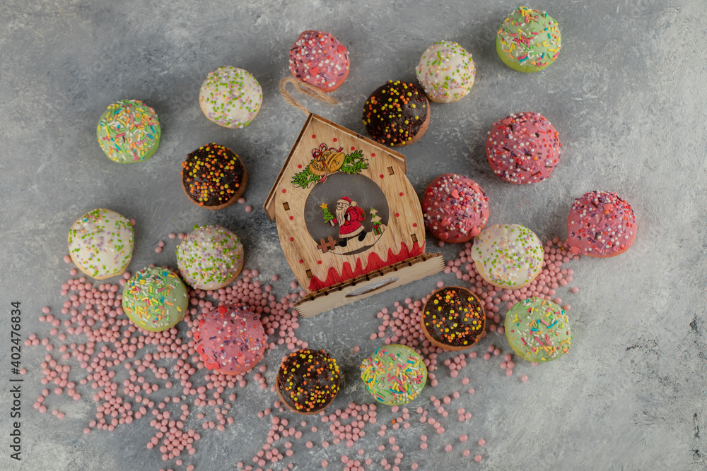 Colorful sweet small doughnuts with sprinkles and a cup of tea Colorful sweet small doughnuts with sprinkles and a cup of tea