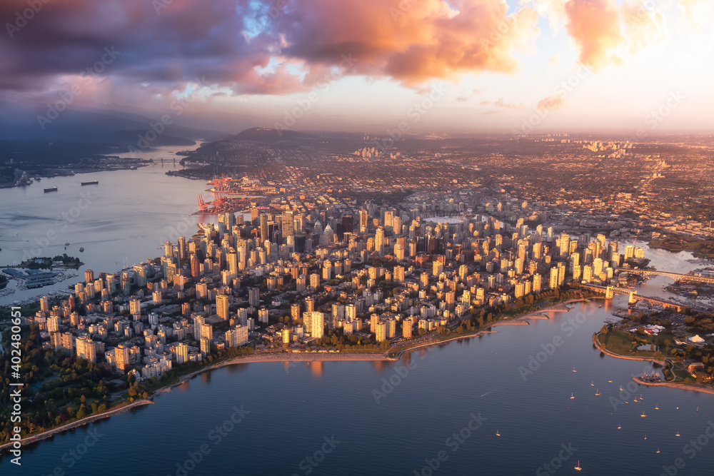 Aerial view of a modern city on the Pacific West Coast. Downtown Vancouver, BC, Canada. Dramatic Colorful Sunset Sky Art Render.