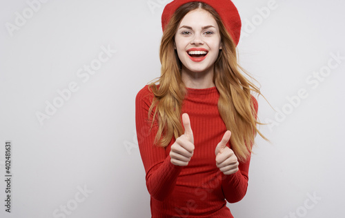 cheerful pretty woman in red dress gesturing with hands isolated background Model