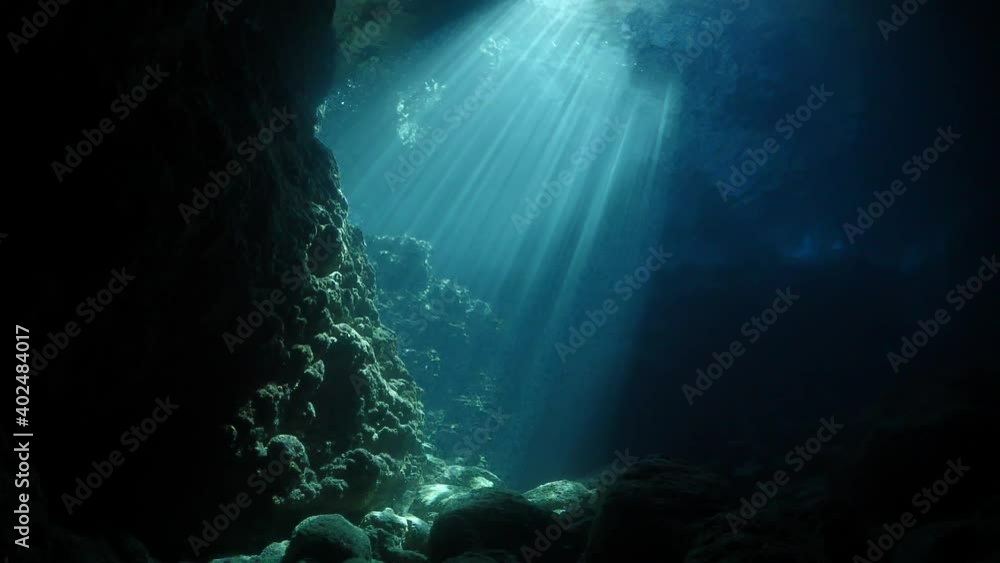 sun rays sun beams and sun shine underwater in cave beautiful light scenery in ocean scuba divers to see