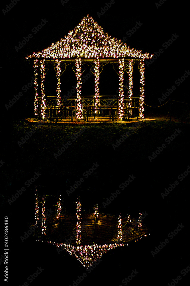 Illuminated garden pavilion at night - obrazy, fototapety, plakaty 