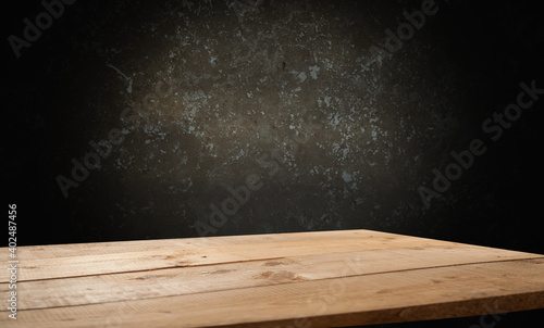 empty wooden table for groceries on dark background