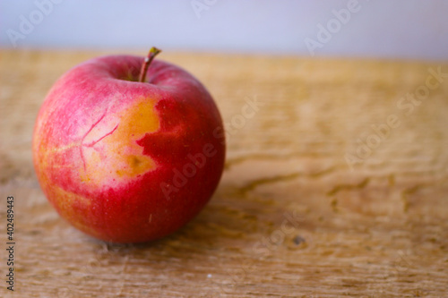Red apple stand on a wooden surface