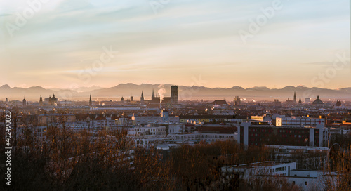 Clean and complete Munich skyline at winter sunrise - with Alps visible in background