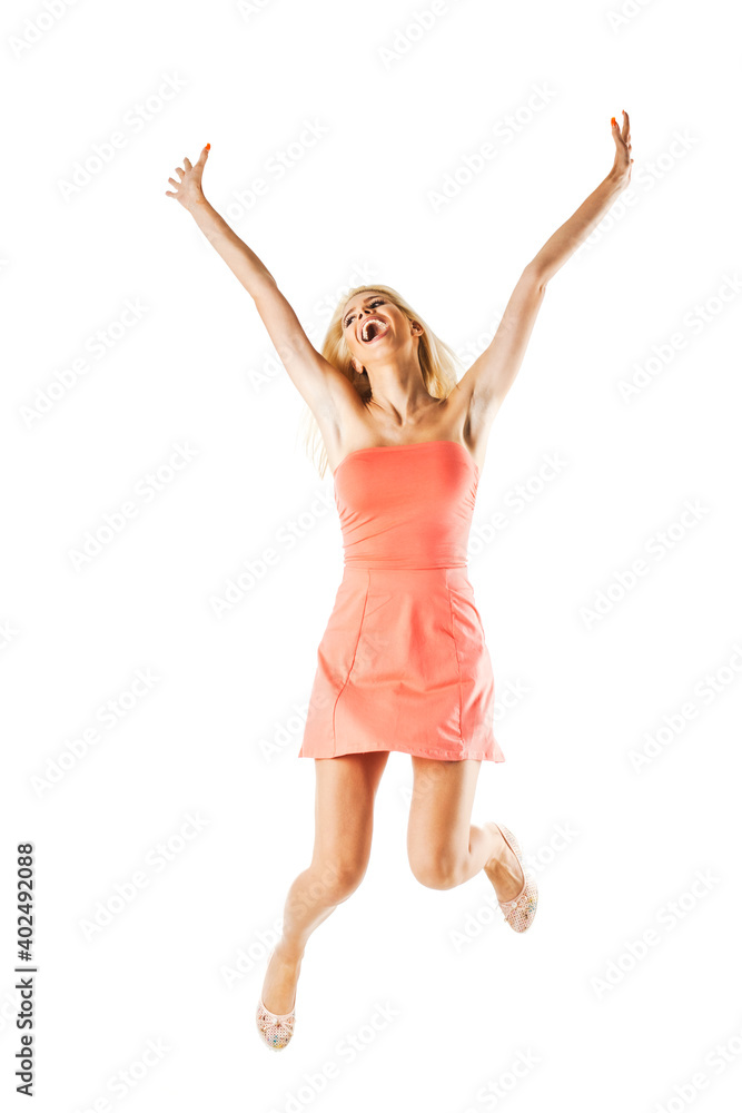 happy blond girl wearing pink dress jumping in the air against white background.