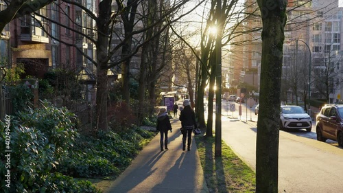 Wallpaper Mural One woman and a child with a protective mask walking down the street outside Torontodigital.ca