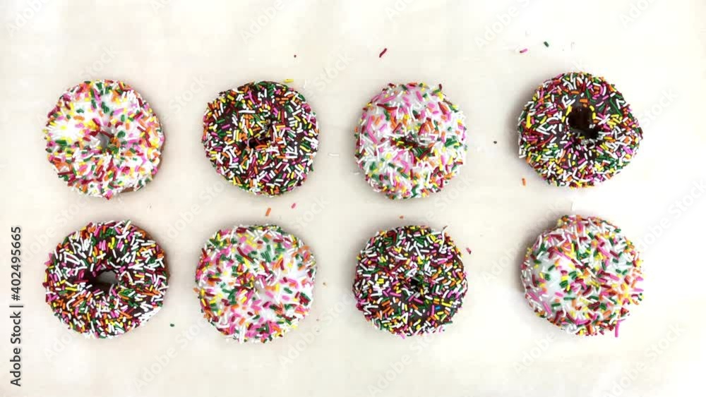 4K HD video cake donuts with chocolate and vanilla icing with candy sprinkles on parchment paper. Hand reaches in to grab a chocolate donut and removes it.
4K HD video cake donuts with chocolate and vanilla icing with candy sprinkles on parchment paper. Hand reaches in to grab a chocolate donut and removes it.