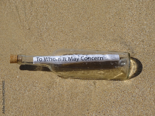 Message in a bottle washed up on a sandy beach.