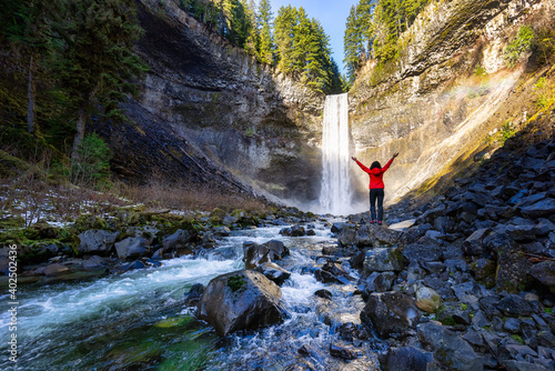 Girl watching a beautiful waterfall in Canadian Nature during winter. Taken in Brandywine Falls, near Whistler and Squamish, North of Vancouver, BC, Canada.