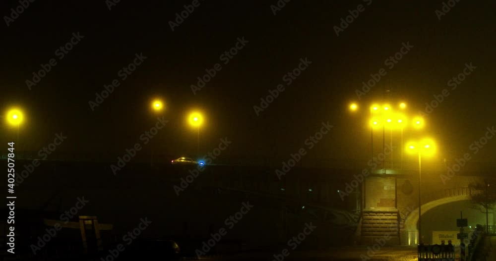 Dark bridge with warm streetlights on a foggy night in Mainz, Germany. Dark bridge with warm streetlights on a foggy night in Mainz, Germany.
