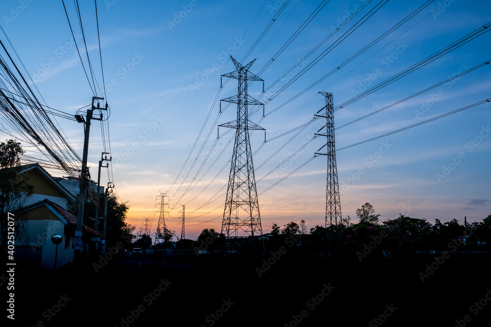 High Voltage Electric Poles and Transmission Towers in the sunrise.