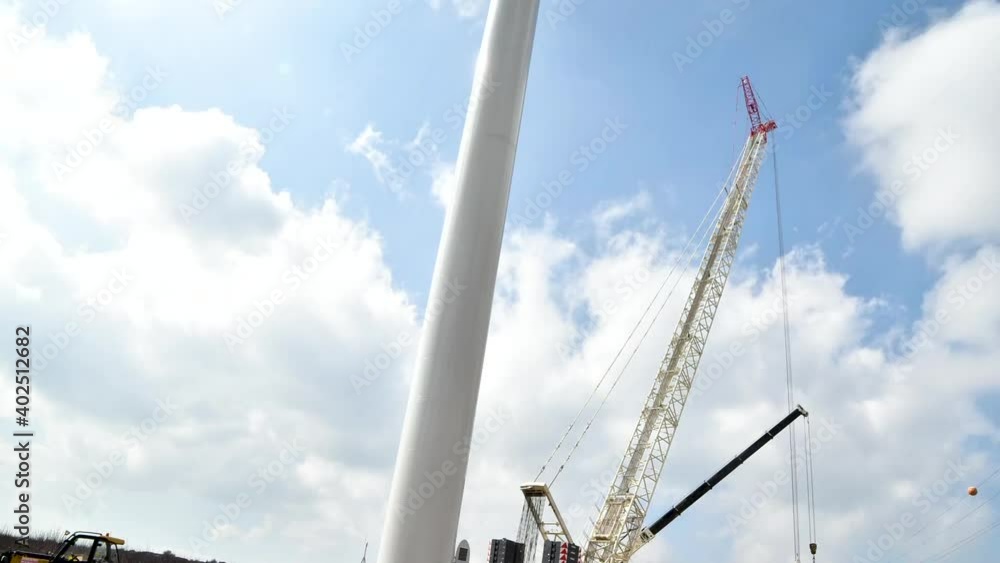 Daytime timelapse of a crane assembling a wind turbine in Israel. Partly cloudy, dynamic following shot. Daytime timelapse of a crane assembling a wind turbine in Israel. Partly cloudy, dynamic following shot.
