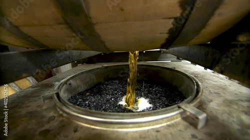 Whiskey Barrel being dumped out at a distillery