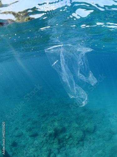 split shot of plastic bag underwater ocean polltion global waste like iceberg © underocean