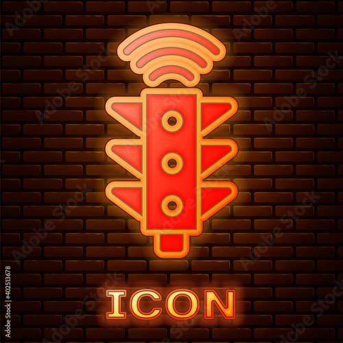 Glowing neon Smart traffic light system icon isolated on brick wall background. Internet of things concept with wireless connection. Vector.