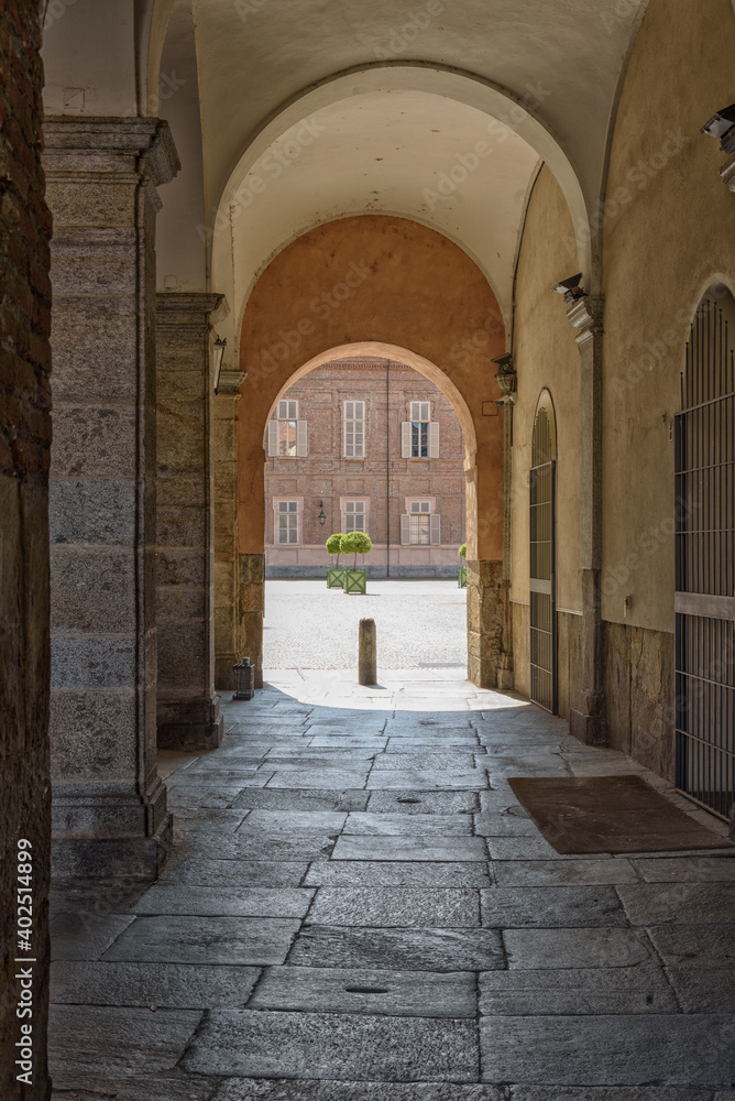 View of the passage gallery that connect Piazza San Giovanni and Piazza Reale in Turin, with the light and shadow contrast in a sunny summer morning