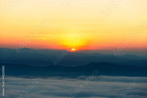 landscape in thailand sunrise on mountains peaceful with mist and sunlight at morning picturesque scenery outdoors travel. © thithawat