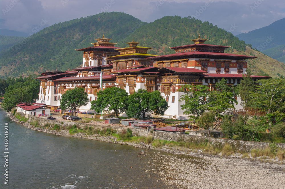 Scenic landscape view of ancient historic landmark Punakha dzong on bank of Mo Chhu river, Western Bhutan 