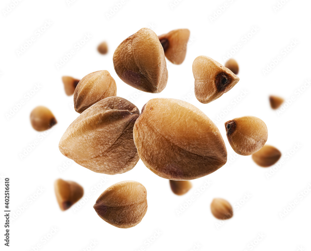 Ripe buckwheat grains levitate on a white background Ripe buckwheat grains levitate on a white background