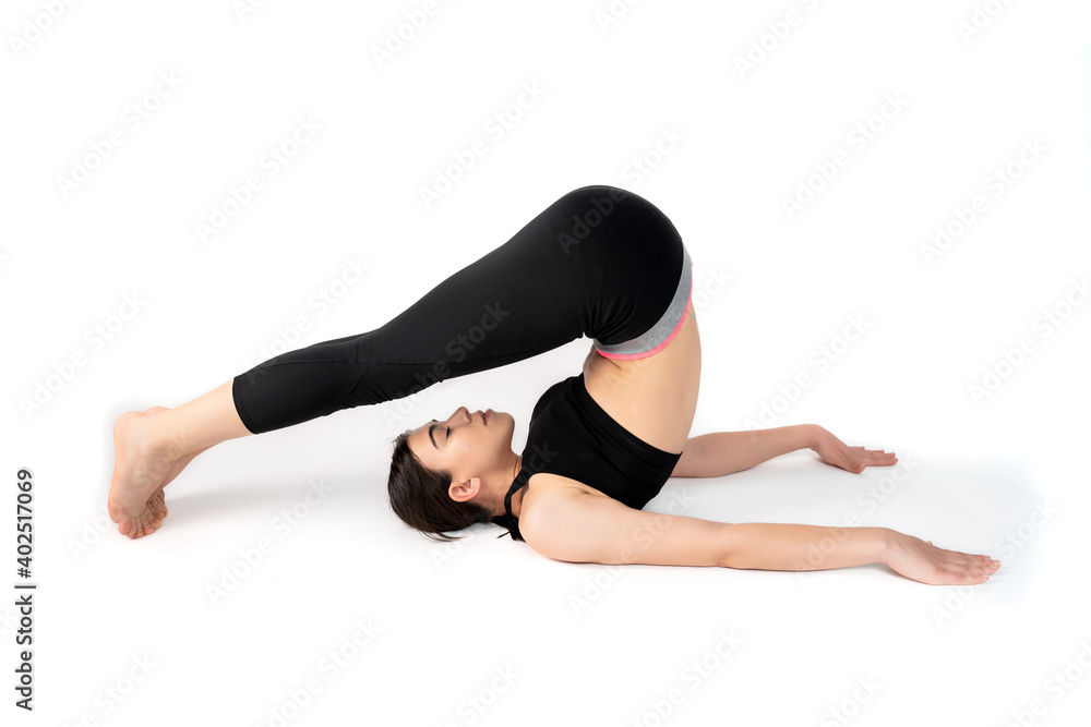 Young woman doing yoga practice isolated on white background. Flexible fit female body. Horizontal shot. High resolution sharp photo. Young woman doing yoga practice isolated on white background. Flexible fit female body. Horizontal shot. High resolution sharp photo.