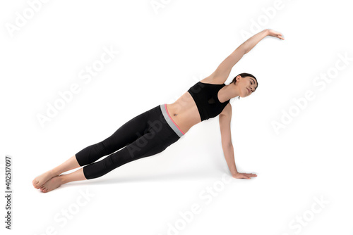Young woman doing yoga practice isolated on white background. Flexible fit female body. Horizontal shot. High resolution sharp photo.