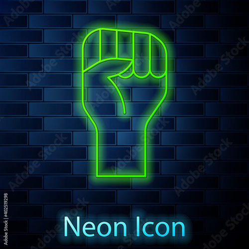 Glowing neon line Raised hand with clenched fist icon isolated on brick wall background. Protester raised fist at a political demonstration. Empowerment. Vector.