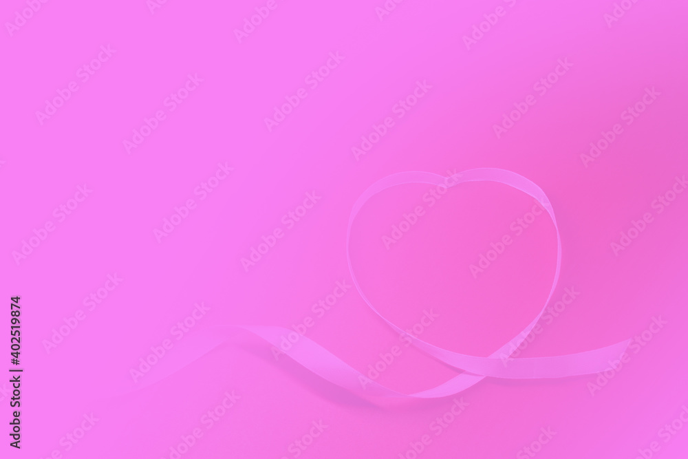Pink heart shape ribbon on pink  background with copy space . Love celebration postcard concept - 14th Valentine's Day 