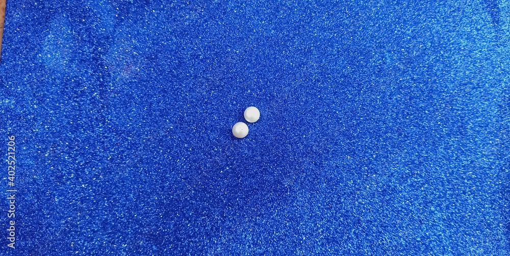 Two real peals like water drops on blue background