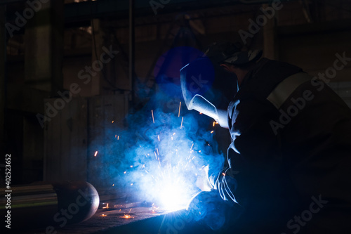 Welders working at the factory made metal