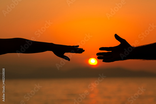 Couple hands at sunset