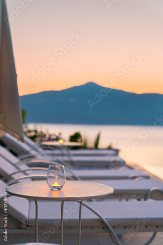 Fototapeta Naklejka Na Ścianę i Meble -  Beautiful tropical sunset scenery, sun beds, loungers, umbrella 