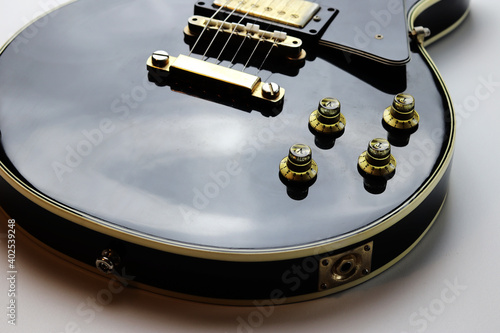 Canvas Print Vintage black and gold colored electric guitar - close up