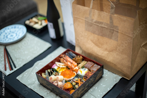 Osechi dinner box over the table at home photo