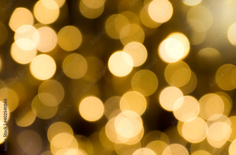 Golden yellow light glowing background in the form of bokeh. Shimmering blur spotlights on multicolored abstract wallpaper. Golden yellow light glowing background in the form of bokeh. Shimmering blur spotlights on multicolored abstract wallpaper.