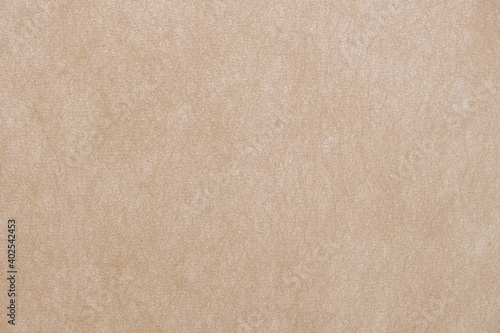 Beige surface background texture light rough textured spotted blank copy space background in beige yellow,brown.