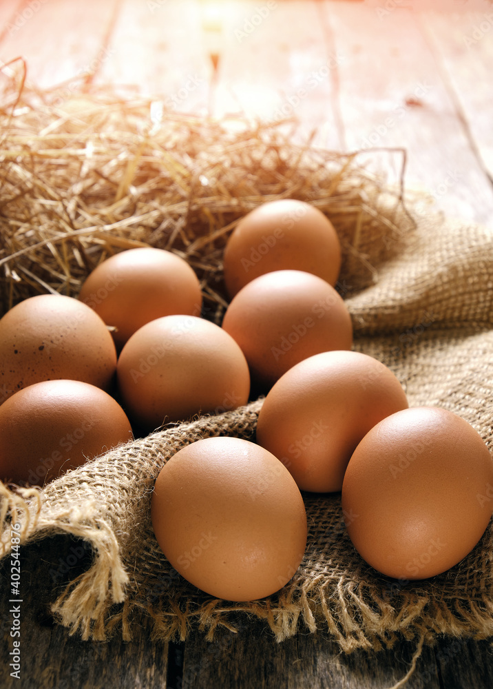 Collected chicken eggs, stacked on burlap in the chicken coop. Collected chicken eggs, stacked on burlap in the chicken coop.
