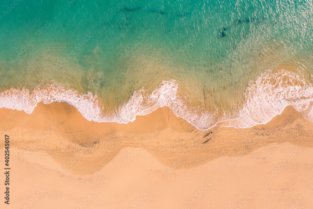 Aerial top down view of beautiful Atlantic ocean coast with crystal clear turquoise water and sandy beach