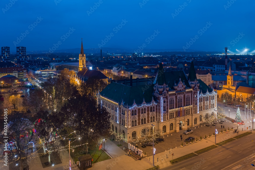 Újpest, Budapest, Hungary - Aerial view of city hall of Ujpest with Queen of Heaven church and Christmas lights. Blue hour cityscape. Újpest városháza.