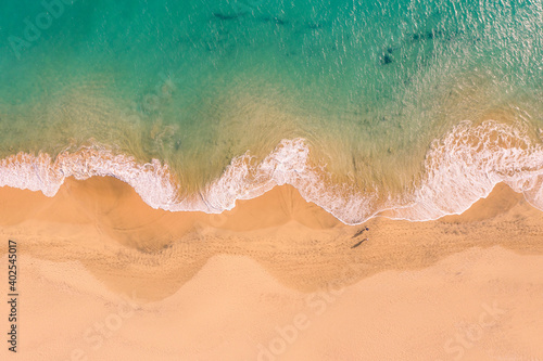Aerial top down view of beautiful Atlantic ocean coast with crystal clear turquoise water and sandy beach