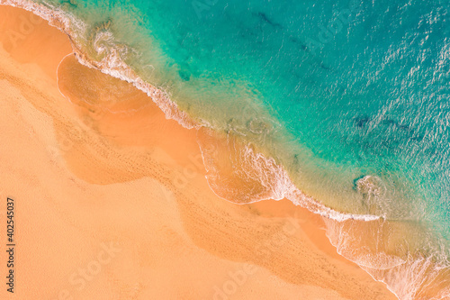 Aerial top down view of beautiful Atlantic ocean coast with crystal clear turquoise water and sandy beach