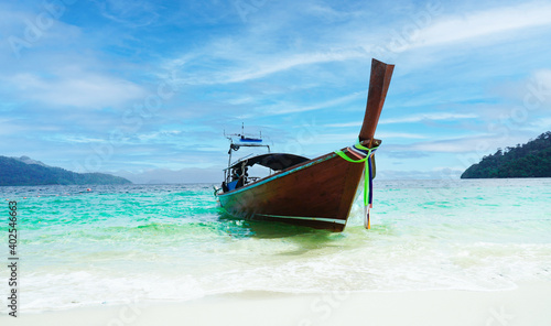 Thai traditional wooden longtail boat and beautiful sand beach at Koh lipe island. © Richman Photo