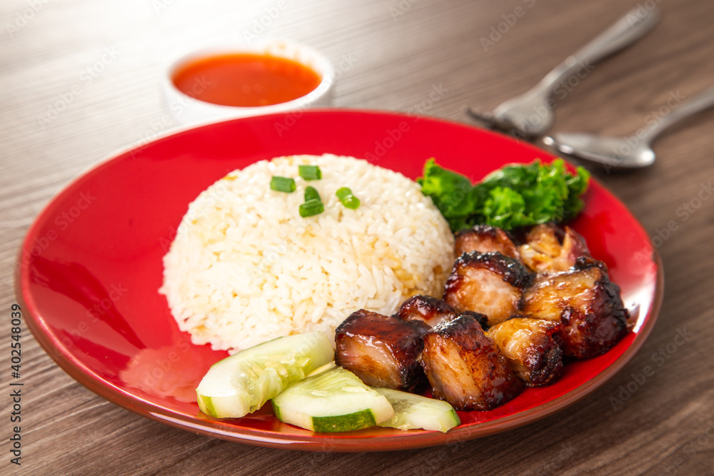 Chinese Sweet Bbq Pork is marinated in a sweet BBQ sauce and served with white rice.
